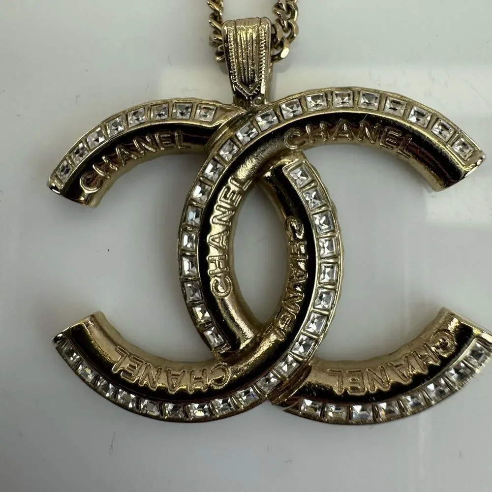 CHANEL Multi Logo Engraved Gold Crystal CC Pendant Necklace